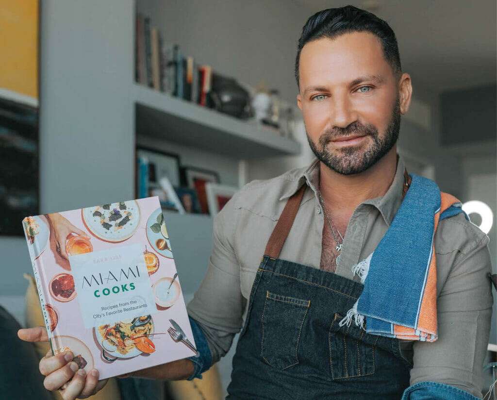 photo of Yaniv Cohen having his book in his hand