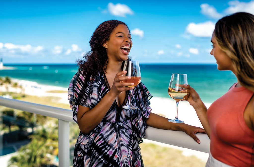 LauderDeals_LauderDeals getaway_2 women on the patio by the beach drinking