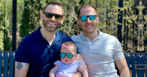 two men with a baby