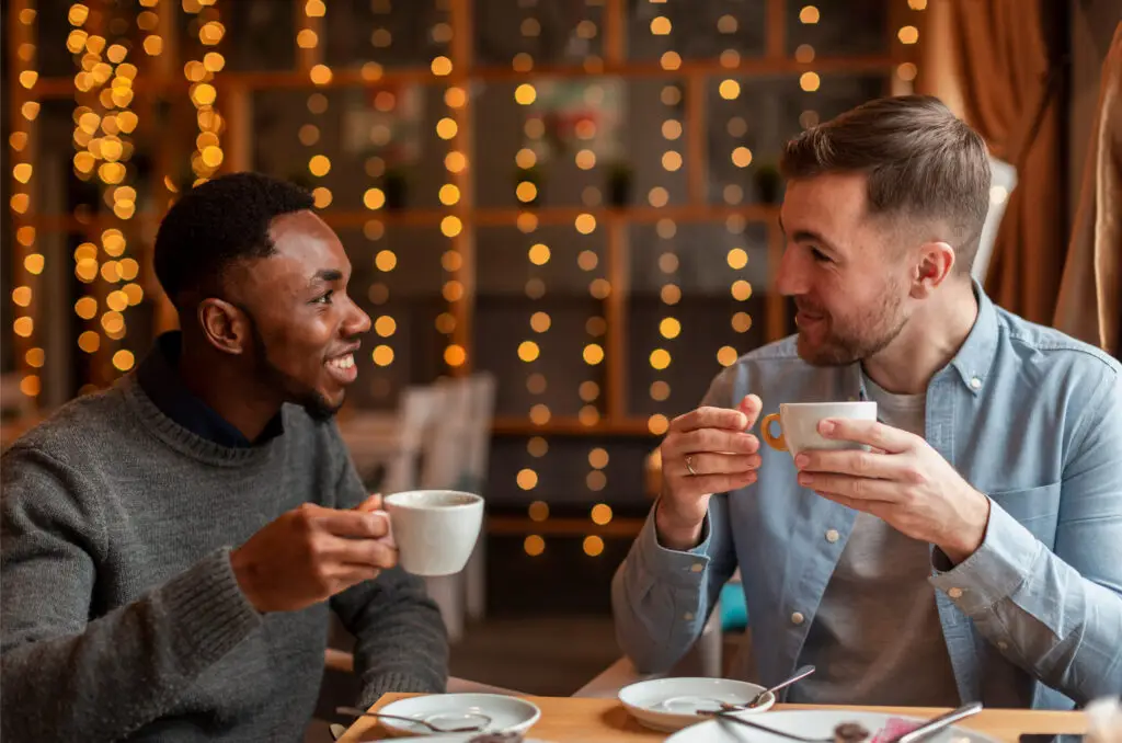male-friends-drinking-coffee-restaurant