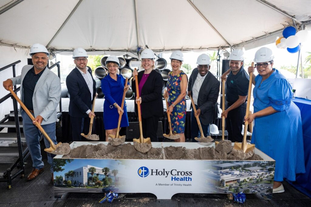 (left to right) Fernando Ramos, MPL Construction Project Manager; Daniel Breitner, MPL Construction Architect; Taren O’Brien, MSN, RN, Vice President and Chief Nursing Officer; Mary Carter Waren, D.Min., Mission Leader; Linda Carter, Holy Cross Health Board Member; Pierre Monice, MBA, FACHE, President & CEO of Holy Cross Health; Christian Fernandez, MPL Construction Project Manager; Brea Elles, Director Planning Design & Construction at the ceremonial shovel box during the groundbreaking ceremony. Credit: Carlos Aristizabal Photo & Video Corp.)