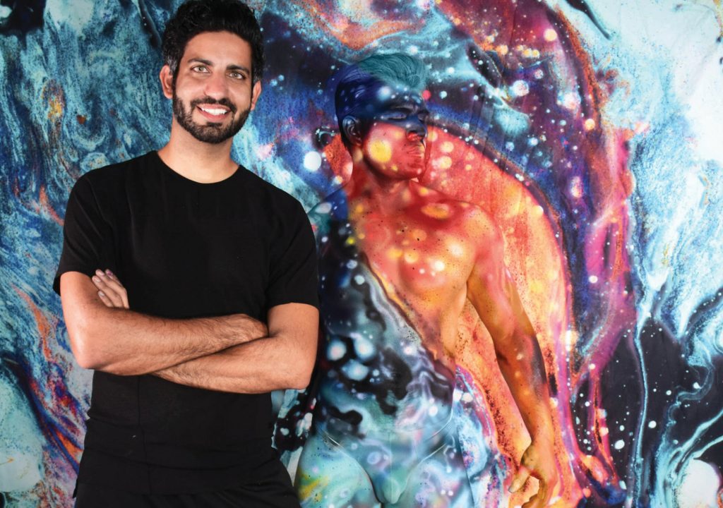 Avi Ram Standing in front of one of his arts