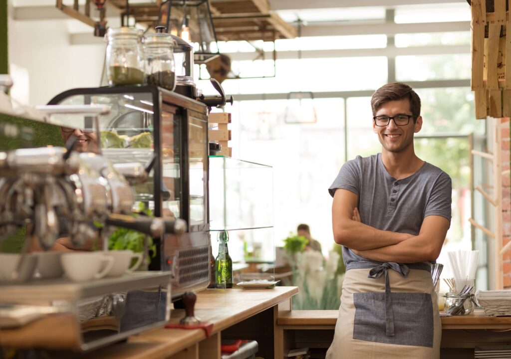 Photo of owner of a local shop standing.
