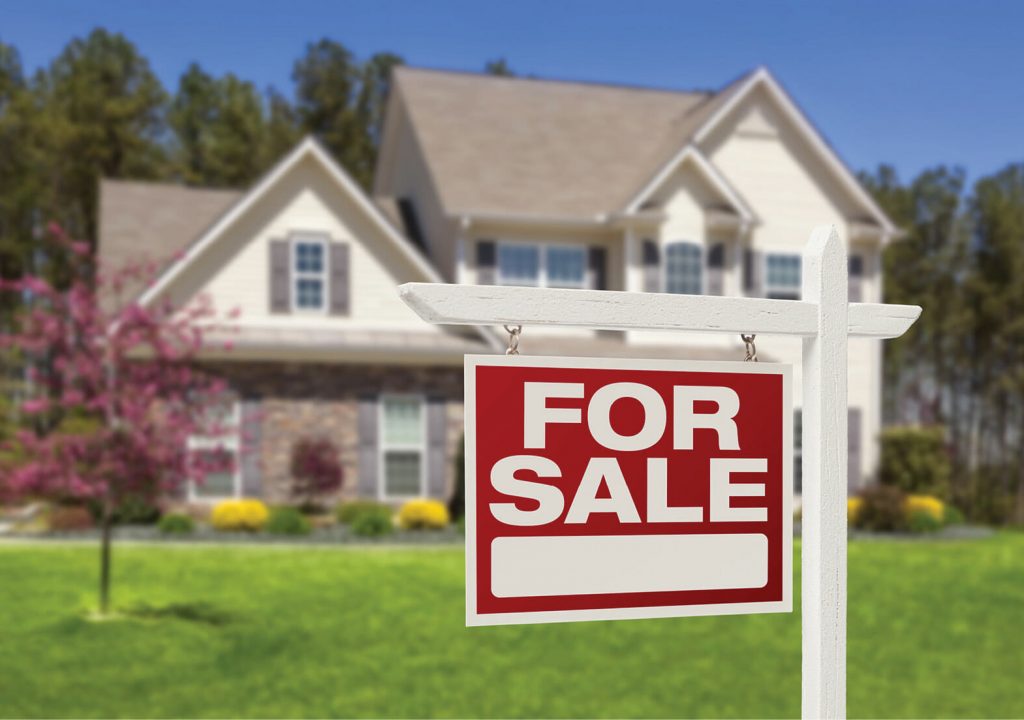 Home For Sale Real Estate Sign and Beautiful New House.