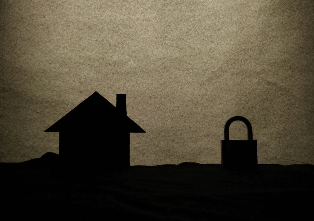 Home security , back-lighting silhouette at home an a lock
