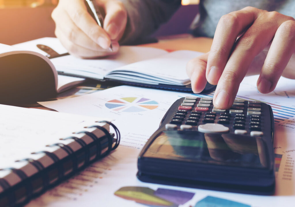 Hand man doing finances and calculate on desk about cost at home office.