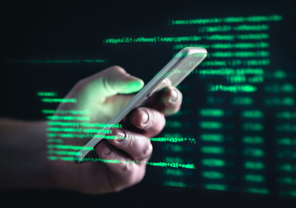 Darkweb, darknet and hacking concept. Hacker with cellphone. Man using dark web with smartphone. Mobile phone fraud, online scam and cyber security threat. Scammer using stolen cell. AR data code.