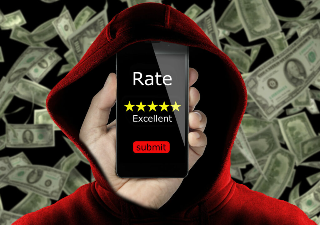 anonymous with hoodie making fake rating and review for money concept conceptual. Untrue feedback in exchange of dollars. Business online ranking is affected from false review by user to gain money.