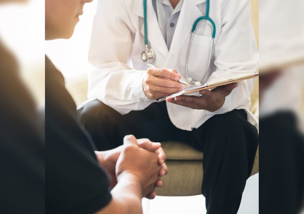 Doctor consulting male patient, working on diagnostic examination on men's health disease or mental illness, and writing on prescription record information document in clinic or hospital office.
