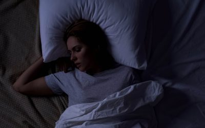 Beautiful female snoring in bed, serious health problems, sleep apnea risk, stock photo