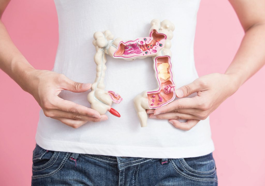 woman with colorectal cancer concept on the pink backgorund
