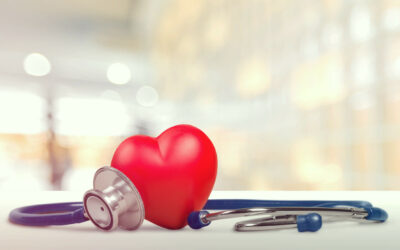 One single alone red heart love shape hand exercise ball with bandage MD medical doctor physician's stethoscope white wood background: Hospital life insurance concept: World heart health day idea