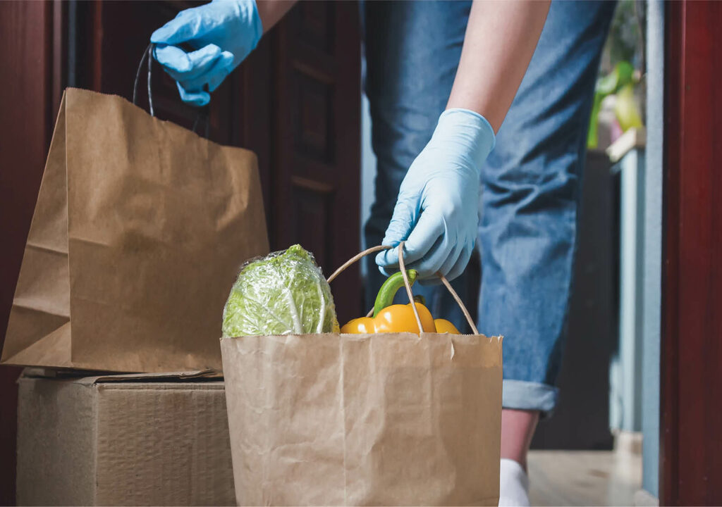 careResource_ a person delivering foods to someone's front door