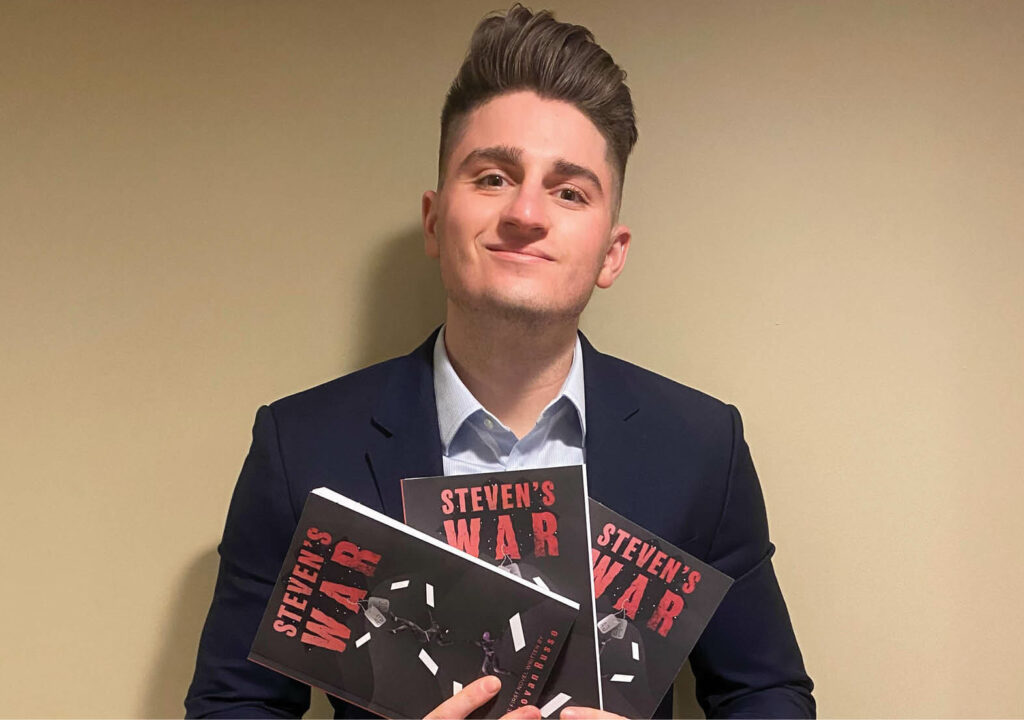 Donovan Russo Holding his new book