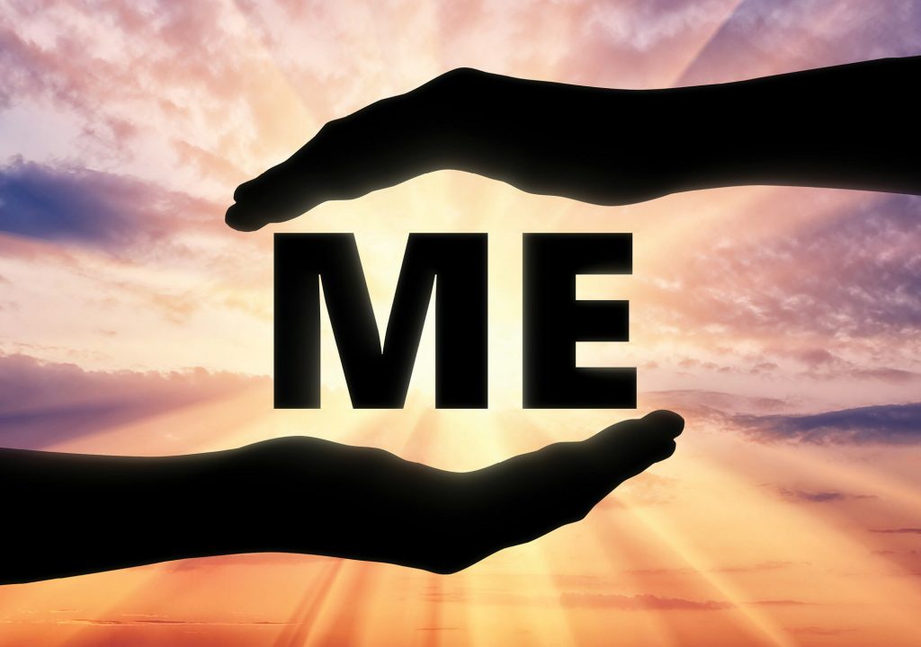 Concept of selfishness and self-love. Silhouette of two hands in the center of word me