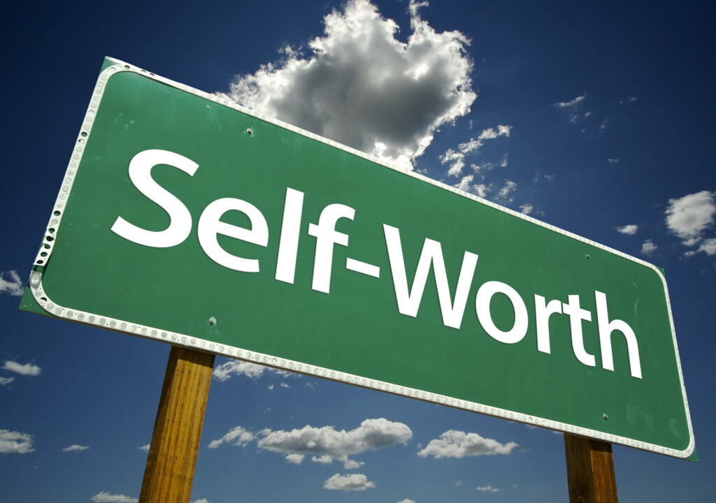 Self-Worth Road Sign with dramatic clouds and sky.