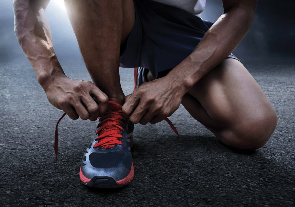 Man tying running shoes