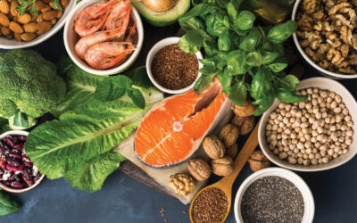 Food sources of omega 3 on dark background with copy space top view. Foods high in fatty acids including vegetables, seafood, nut and seeds. Health food fitness