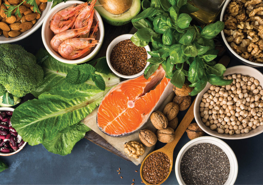 Food sources of omega 3 on dark background with copy space top view. Foods high in fatty acids including vegetables, seafood, nut and seeds. Health food fitness