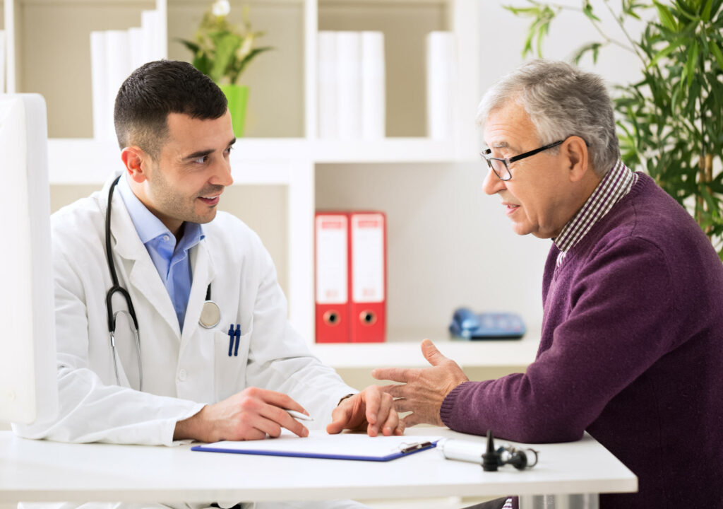 Doctor listening to patient explaining his painful in his office