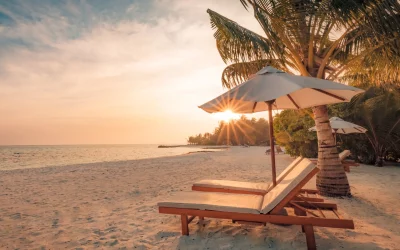 Beautiful sunset beach. Chairs on the sandy beach near the sea. Summer holiday and vacation concept. Inspirational tropical scene. Tranquil beach scene. Exotic tropical beach landscape for background or wallpaper. Design of summer vacation holiday concept.