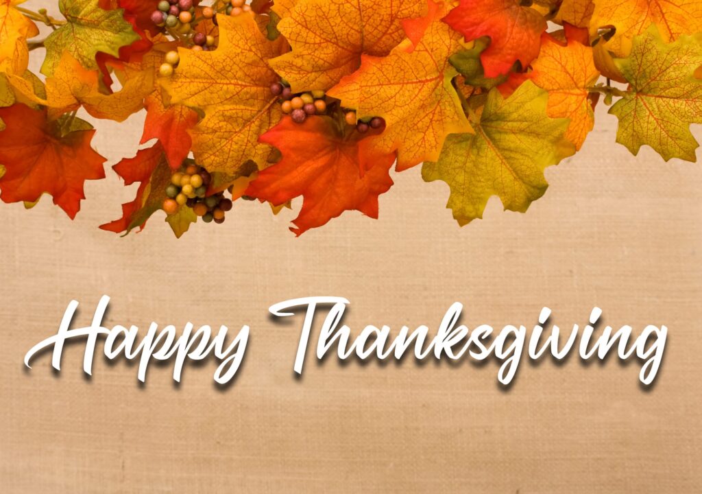 Fall leaves making a border on a beige background, fall border and a text of Happy Thanksgiving