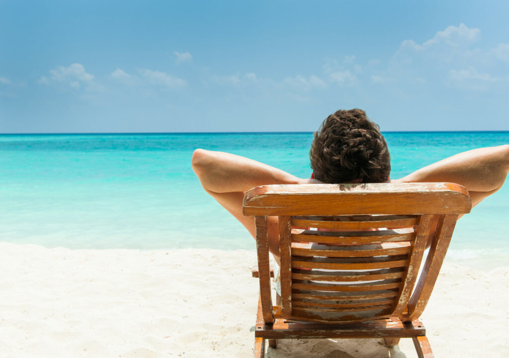Man relaxing on beach, ocean view, Maldives island