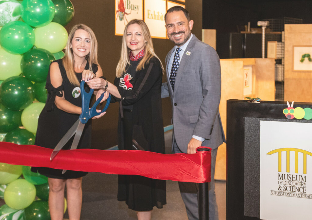 Ann Fonts, Caitlin Stella and Joseph P. Cox cutting the ribbon