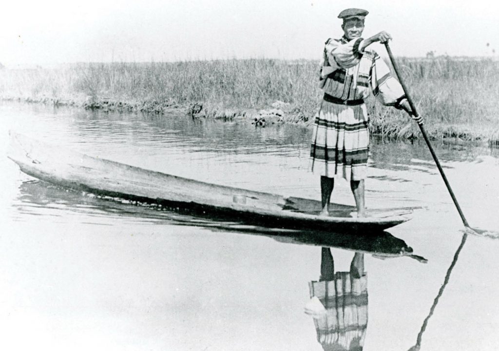 Seminole Indian Charlie Cypress Poling a Dugout in the Everglades 1937