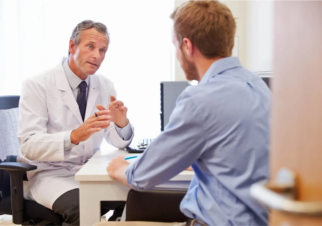Male Patient Having Consultation With Doctor In Office