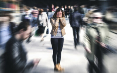 Panic attack in public place. Woman having panic disorder in city. Psychology, solitude, fear or mental health problems concept. Depressed sad person surrounded by people walking in busy street.