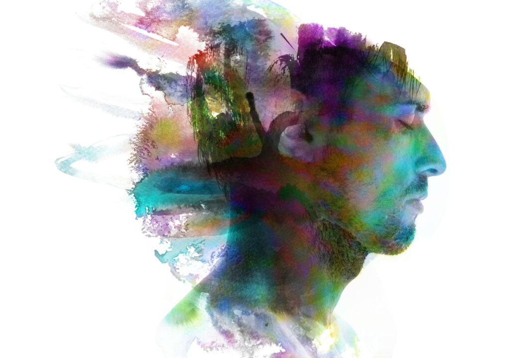 Profile portrait of a sexy man with a colourful painting dissolving behind him